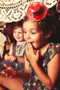 Party Girls eating sweet and sour candy spaghetti under the table Party Girls eating sweet and sour candy spaghetti under the table